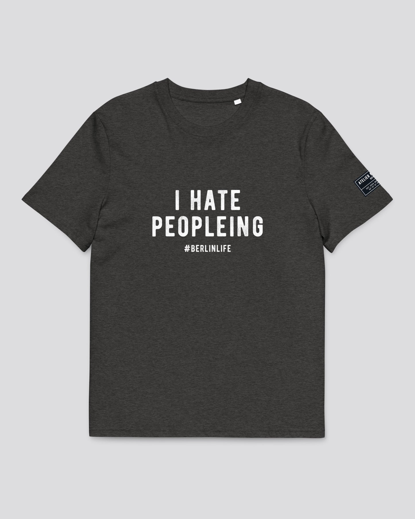 Dark gray t-shirt with white text 'I HATE PEOPLEING #BERLINLIFE' on a light gray background